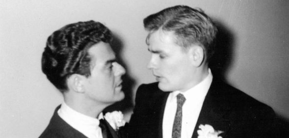 Two grooms looking at each other lovingly