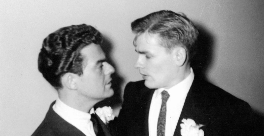 Two grooms looking at each other lovingly