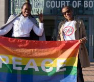Activists pose with a rainbow flag as they celebrate outside Botswana High Court in Gaborone on June 11, 2019.