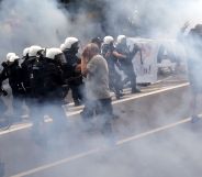 Riot police fire tear gas to disperse people, including ultra-nationalists, who attempted to block the first gay pride march on July 20, 2019 in Bialystok, eastern Poland