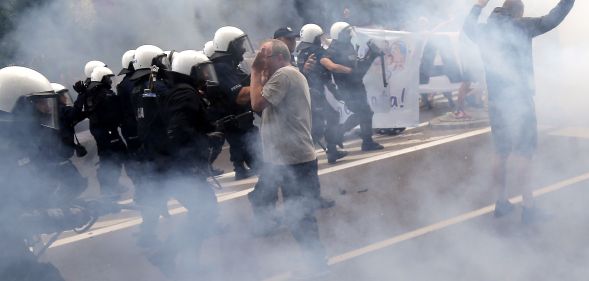 Riot police fire tear gas to disperse people, including ultra-nationalists, who attempted to block the first gay pride march on July 20, 2019 in Bialystok, eastern Poland