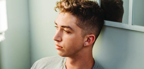 man sitting against wall