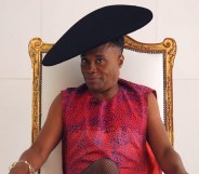 Billy Porter, wearing a dress and sat in a throne, speaks exclusively to PinkNews