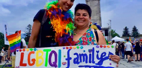 Crstina Palma and her wife holding a sign reading "LGBTQI family mobility in EU"