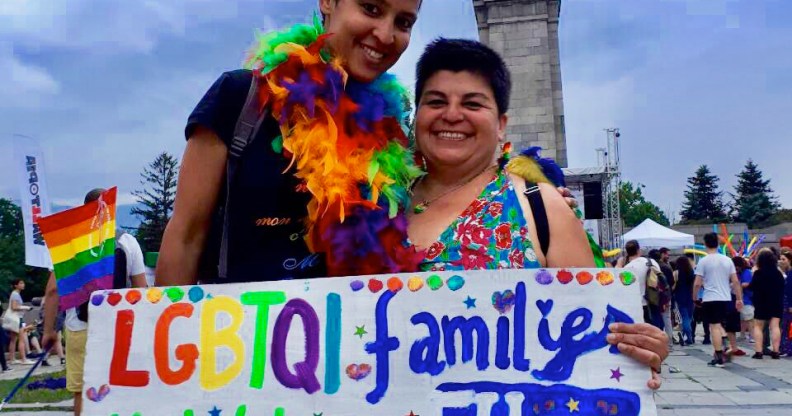 Crstina Palma and her wife holding a sign reading "LGBTQI family mobility in EU"