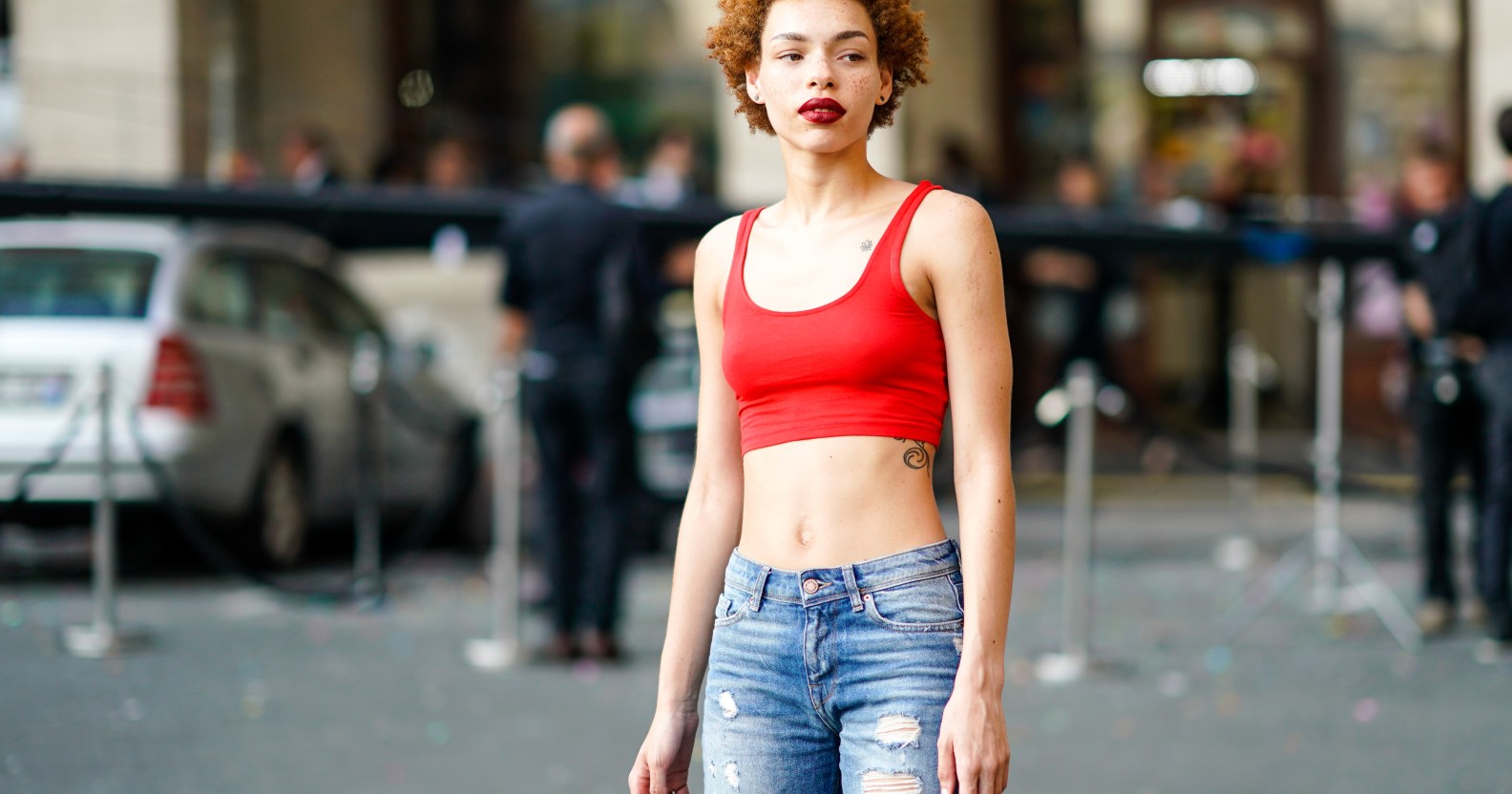 Carissa Pinkston wearing a red bra top and jeans