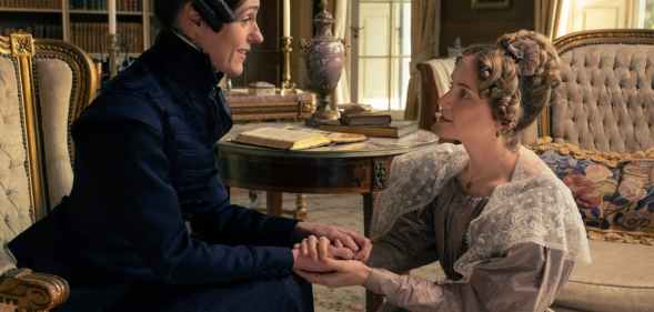 Anne Lister sitting down, holding hands with Ann Walker who is on bended knee
