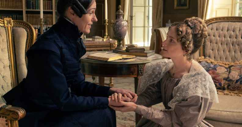 Anne Lister sitting down, holding hands with Ann Walker who is on bended knee