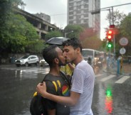 Two men kissing in the rain during a Pride event in Kolkata