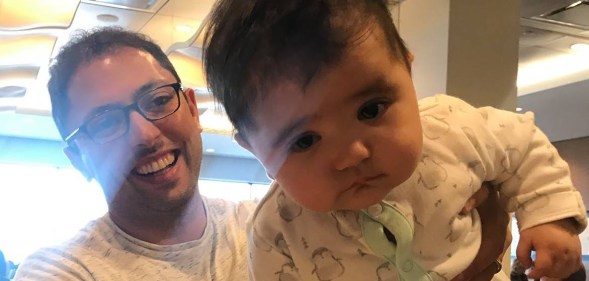 Jonathan Gregg holding his daughter