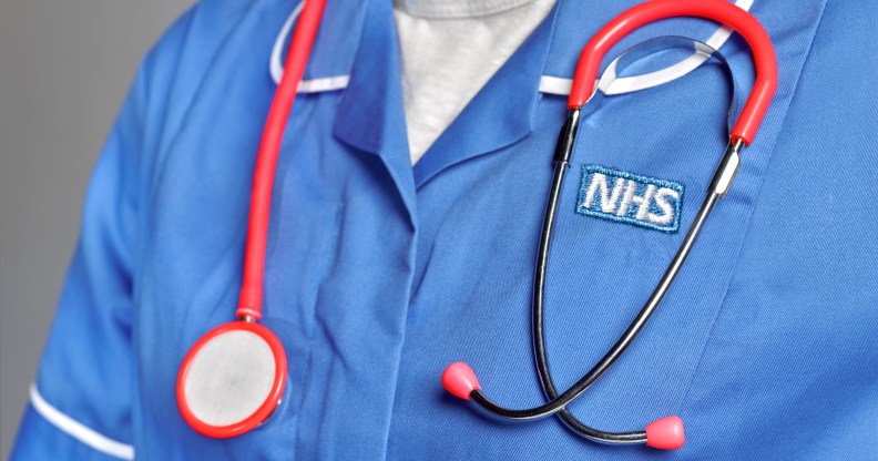 A close-up of somebody wearing an NHS uniform with a stethoscope around their neck.