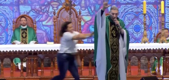 Woman pushes anti-gay priest off stage in Brazil