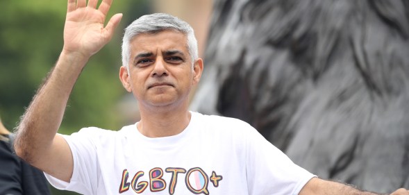 Sadiq Khan waving, wearing an "LGBTQ ally" t-shirt