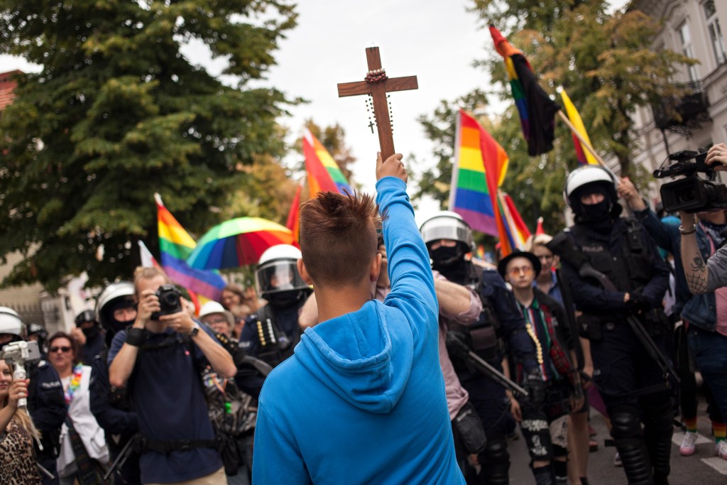 15yearold boy holding crucifix blocks LGBT march in Poland PinkNews