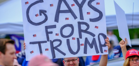 LGB Republican holds banner that reads 'Gays for Trump'
