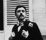 French author Marcel Proust sitting outside a window.