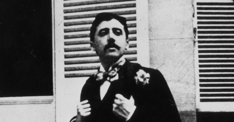 French author Marcel Proust sitting outside a window.