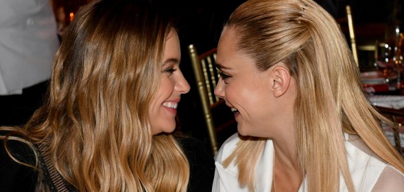 Cara Delevingne and Ashley Benson facing each other, smiling