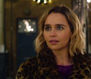 Emilia Clarke looking wide-eyed in a leopard-print coat
