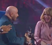 John Travolta handing an award to Jade Jolie