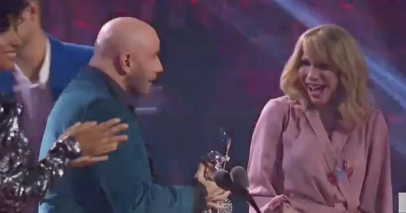 John Travolta handing an award to Jade Jolie