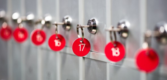 A close-up of grey metal lockers with red key numbers