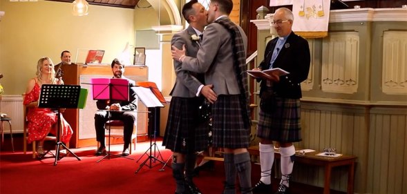 Jamie Wallace and Ian McDowall kissing at the altar