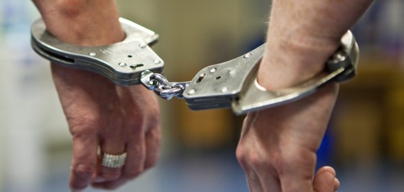 A prisoner's hands in handcuffs