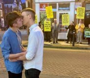 A gay couple showed their defiance against a group of religious protesters in the best way possible. (Joe Fergus and Robert Brookes)
