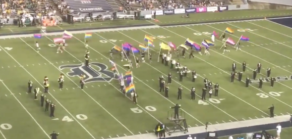 Marching band members at Rice University take to the stadium field raising and waving Pride flags. (Screen capture via Twitter/@ricemob)