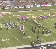 Marching band members at Rice University take to the stadium field raising and waving Pride flags. (Screen capture via Twitter/@ricemob)