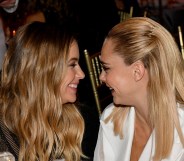Ashley Benson and Cara Delevingne smiling at each other