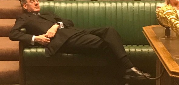 Jacob Rees-Mogg reclining in parliament