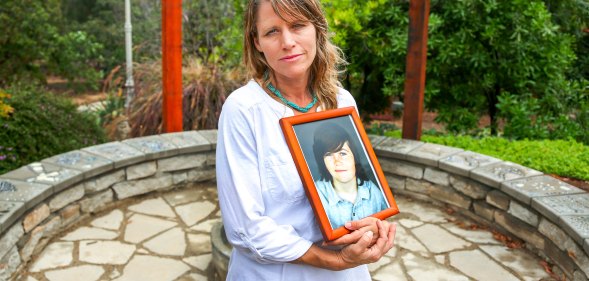 Katharin Prescott holding a photo of her son Kyler