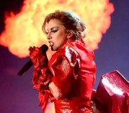 Lady Gaga in red leather infront of a column of flames