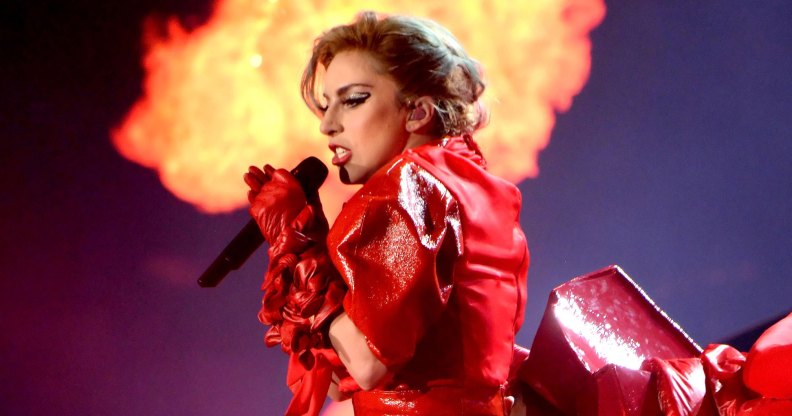Lady Gaga in red leather infront of a column of flames