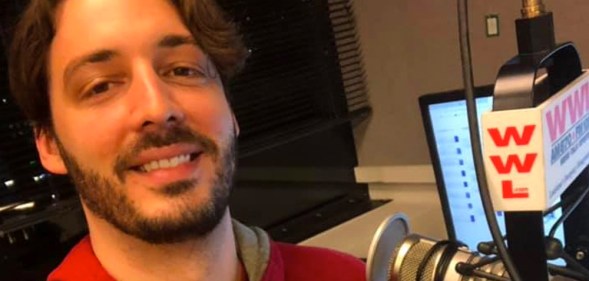 Gay radio host Seth Dunlap speaking into a radio microphone