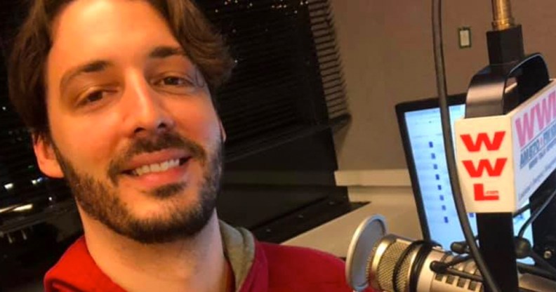 Gay radio host Seth Dunlap speaking into a radio microphone