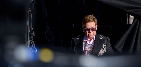 Elton John arrives on stage for his Farewell Yellow Brick Road tour. (FABRICE COFFRINI/AFP/Getty Images)