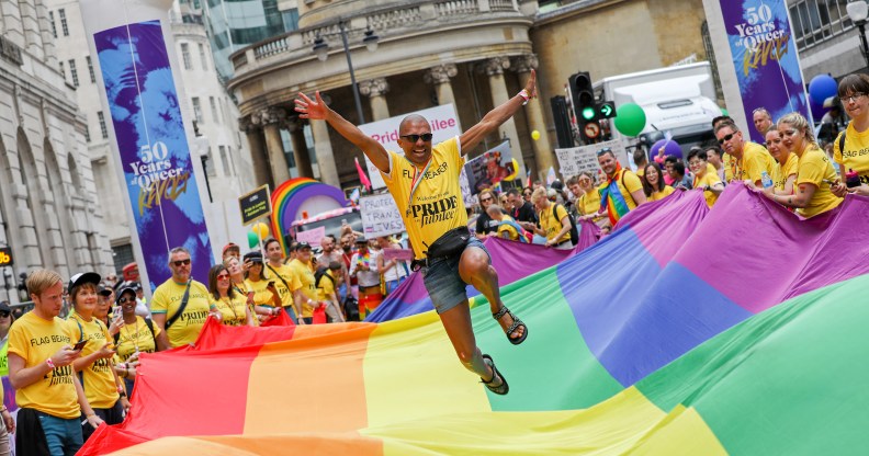 A general view a flag bearer jumping on the giant Pride flag during Pride in London 2019 on July 06, 2019 in London, England.