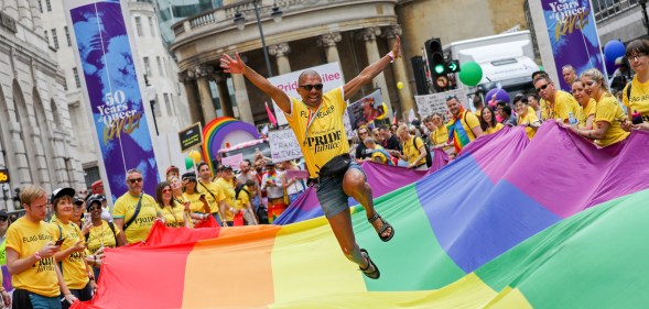 A general view a flag bearer jumping on the giant Pride flag during Pride in London 2019 on July 06, 2019 in London, England.