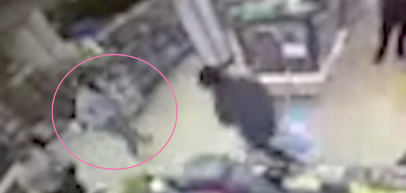 In CCTV footage, the man (highlight by a pink circle) is beelined by two men in a 7-Eleven. (Screen capture via NBC10)