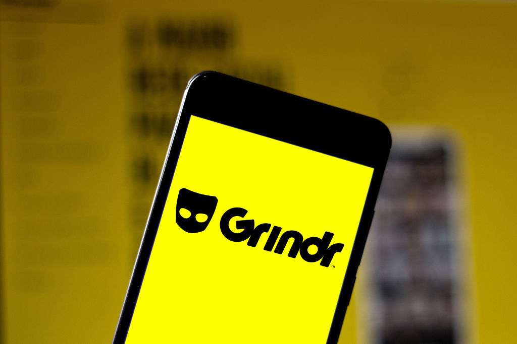 An iPhone showing the Grindr logo