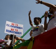 Members of Imaan wave from atop a float during the EuroPride parade.