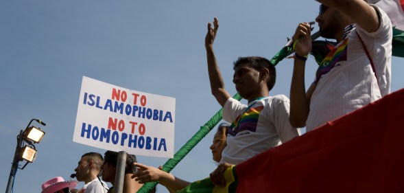 Members of Imaan wave from atop a float during the EuroPride parade.