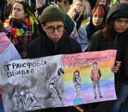 Participants hold drawings reading 'Transphobia kills, humanity saves' during an anti-transphobia rally in Kyiv, on November 23, 2019. (GENYA SAVILOV/AFP via Getty Images)