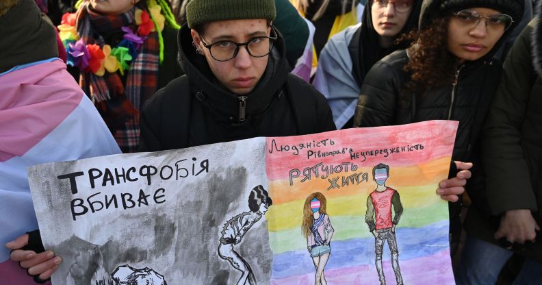 Participants hold drawings reading 'Transphobia kills, humanity saves' during an anti-transphobia rally in Kyiv, on November 23, 2019. (GENYA SAVILOV/AFP via Getty Images)