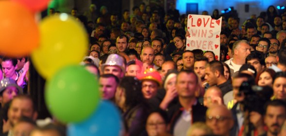 People gather to celebrate in Saint George's Square after the Maltese parliament approved a civil unions bill in Valletta on April 14, 2014. (Matthew Mirabelli/AFP via Getty Images)