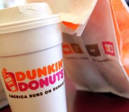 A cup of Dunkin' Donuts coffee and a donut bag sit on a counter. (Tim Boyle/Getty Images)