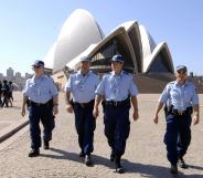 Police officers patrol in front of the Sydney Opera House